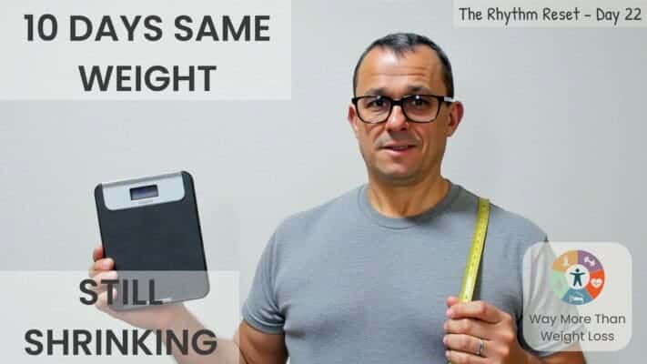 Man holding scale showing weight plateau during 70-day fasting challenge