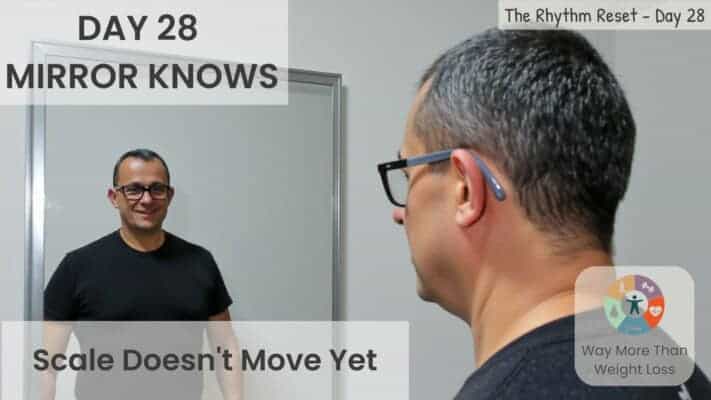 Man looking in mirror noticing visual changes during fasting journey Day 28
