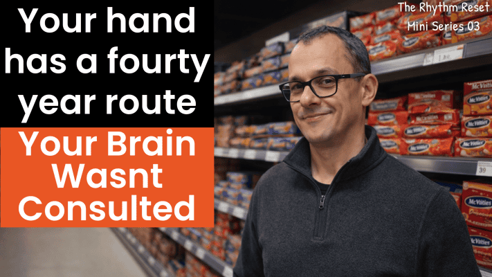 Man's hand reaching for biscuits on desk, illustrating autopilot eating habits
