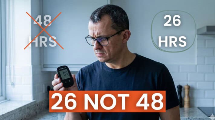 Neil holding ketone meter showing GKI 2.7 result at 26 hours fasted