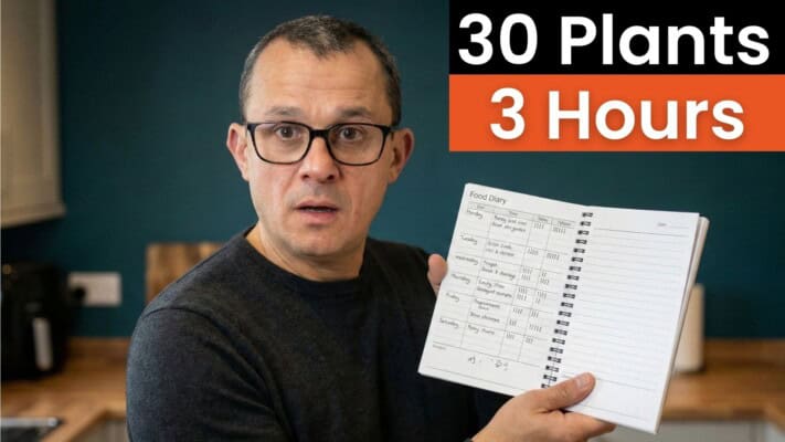 Neil holding food diary showing 30 plants tracked in a 3-hour eating window
