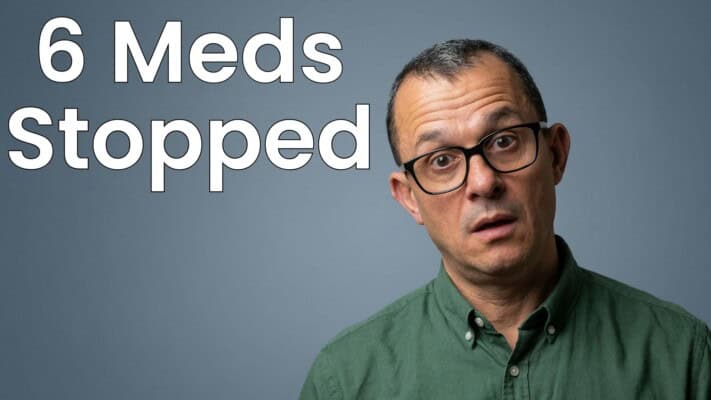 Neil holding six empty medication boxes after stopping all prescriptions February 2024
