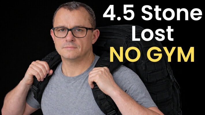 Neil holding 28kg rucksack representing 4.5 stone lost without gym training
