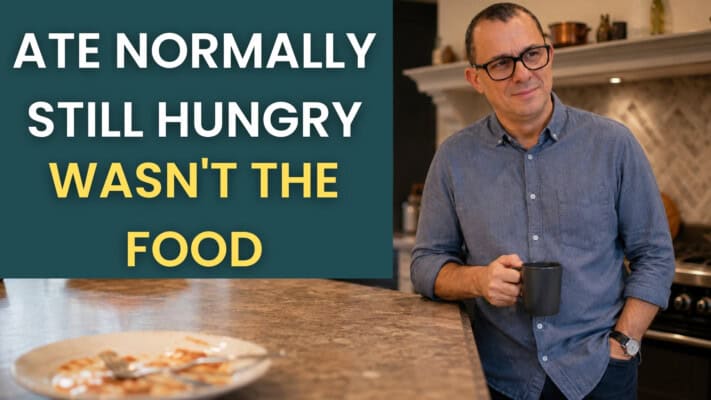 Neil at kitchen counter looking puzzled at food after ultra-processed food disrupted hunger signals
